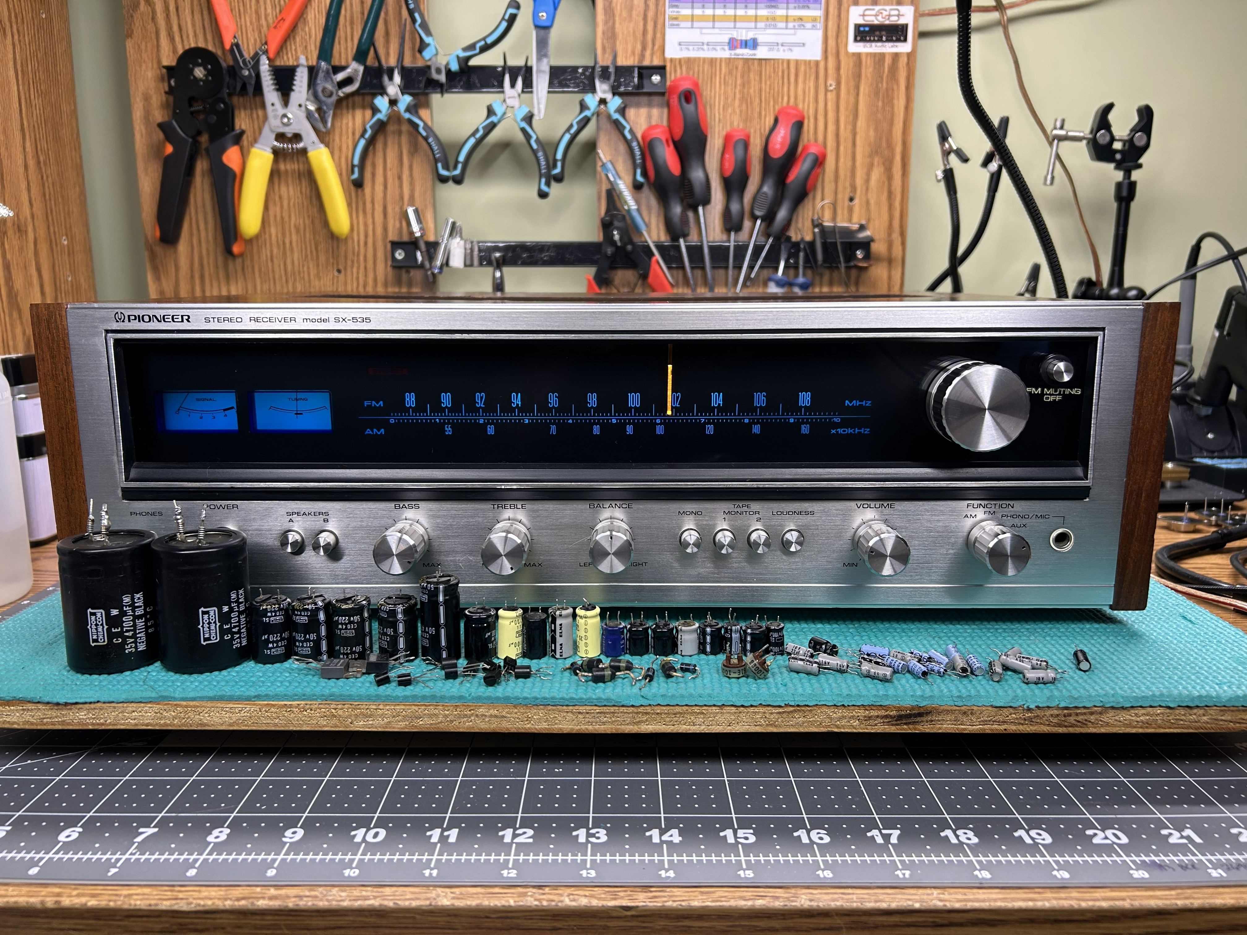 Restored Pioneer SX-535 with original components displayed on the bench