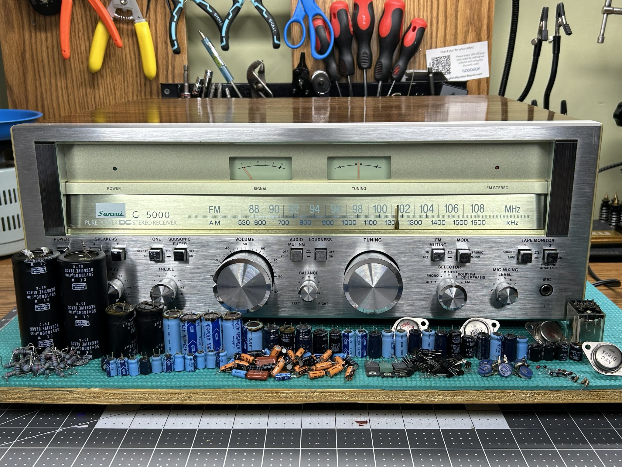Restored Sansui G-5000 with removed components displayed on the bench