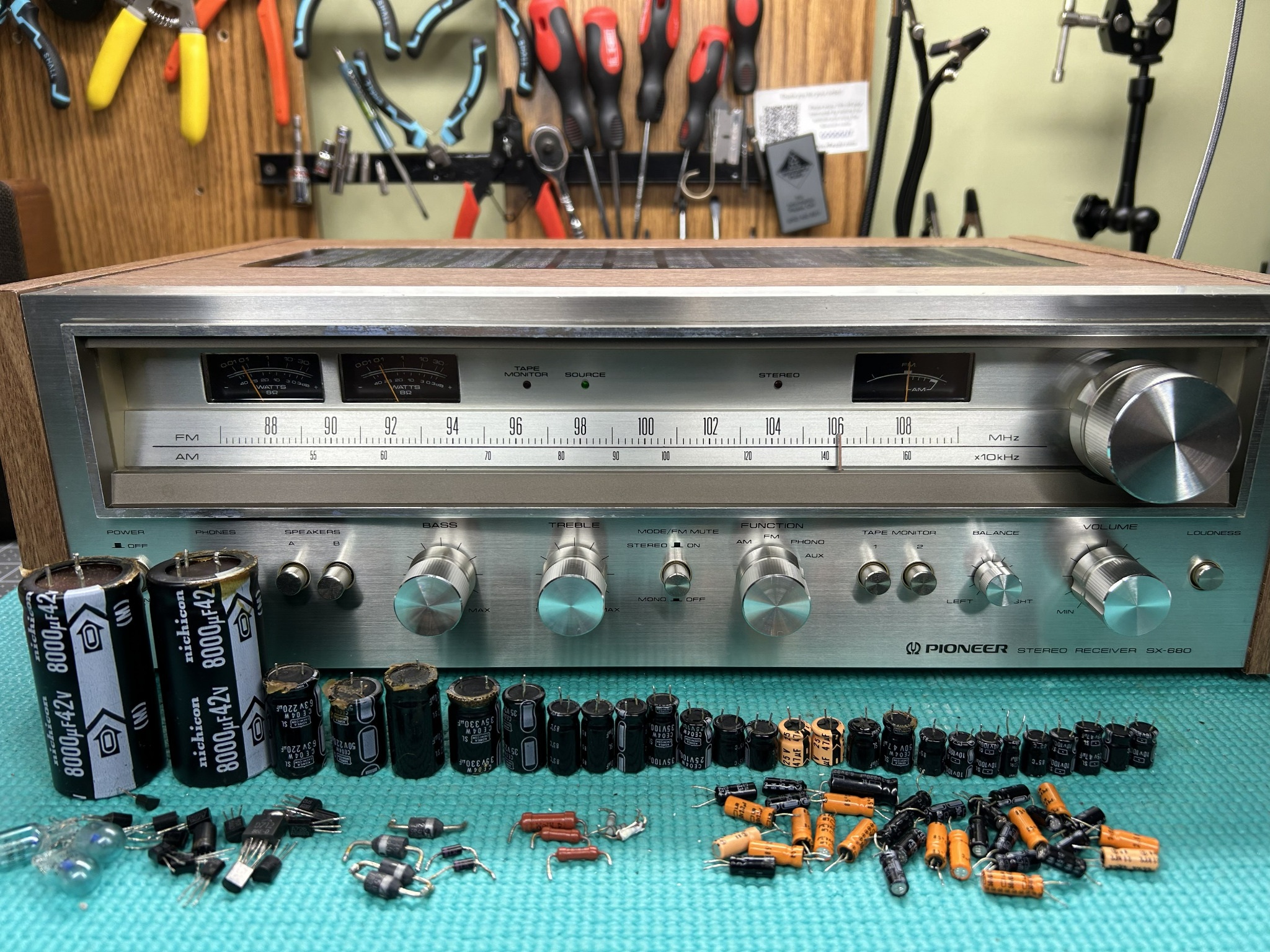 Restored Pioneer SX-680 with original components displayed on the bench